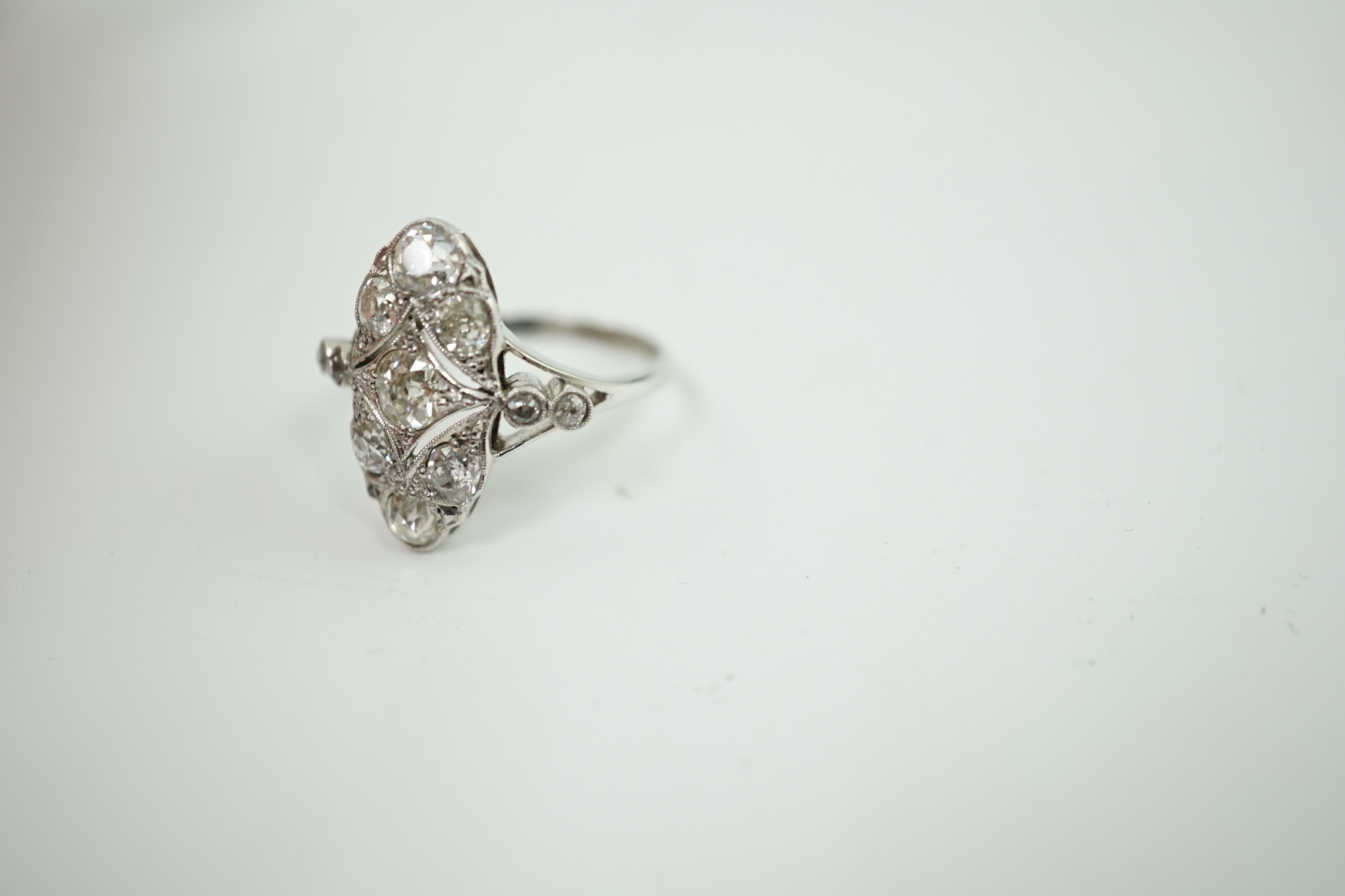 An early 20th century 18ct white gold, platinum and millegrain set old cut diamond cluster ring